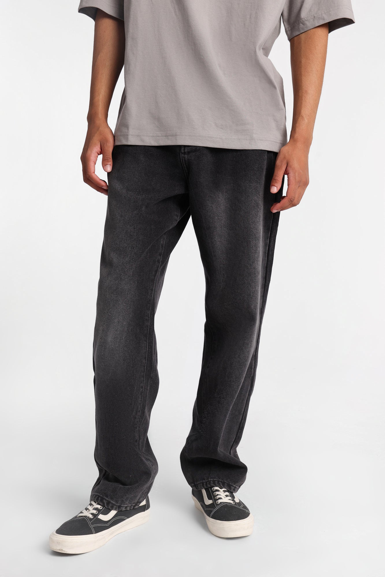 Model wearing loose-fit black jeans